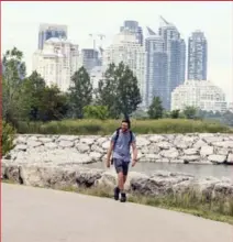  ?? ANDREW FRANCIS WALLACE/TORONTO STAR ?? Day 7, nearing the end. Ballingall walks the lakeshore in Mimico toward downtown.