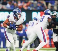  ?? John Munson / Associated Press ?? The Giants’ Saquon Barkley runs the ball during the second half against the Eagles on Sunday.