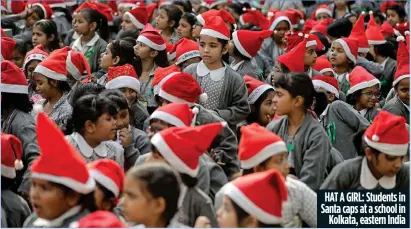  ?? ?? HAT A GIRL: Students in Santa caps at a school in Kolkata, eastern India