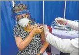  ?? PTI PHOTO ?? A woman receives COVID-19 vaccine dose at RML hospital in Lucknow, Thursday.