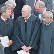  ?? Paul J. Richards AFP/Getty Images ?? ANTHONY M. KENNEDY with Chief Justice John Roberts, left, and Justice Clarence Thomas, right.