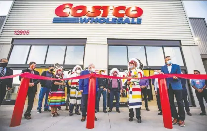  ?? AZIN GHAFFARI ?? Chief Roy Whitney of Tsuut’ina Nation cuts the ribbon at the opening ceremony of the Calgary area’s newest Costco warehouse in Taza on the Tsuut’ina Nation on Friday. This is Costco’s first warehouse located on a First Nation developmen­t in North America.