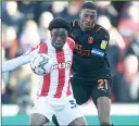  ?? ?? TIGHT: Blackpool’s Marvin Ekpiteta marks Stoke forward Josh Maja