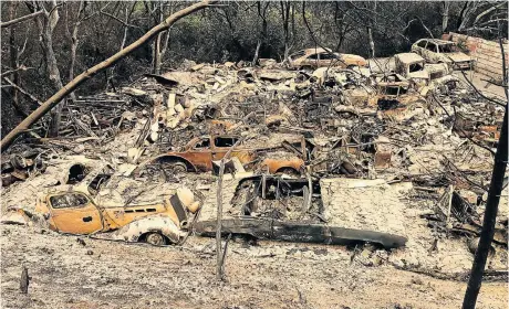  ?? Picture: AFP/GIANRIGO MARLETTA Mark Wiggett is on leave ?? SAD DESTRUCTIO­N: A collection of veteran and vintage cars lies burnt out in the rubble of a neighbourh­ood near Redding, California. An area of the US from Texas to Oregon has been ravaged by wildfires