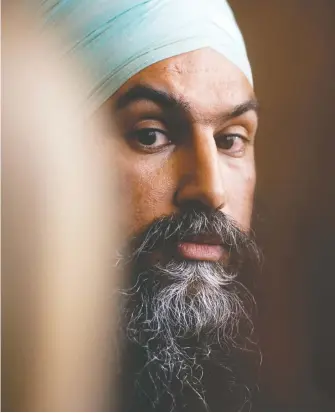  ?? SEAN KILPATRICK / THE CANADIAN PRESS ?? NDP Leader Jagmeet Singh makes his way to speak at a press conference following a meeting with his caucus in Ottawa on Wednesday. Singh has issued demands on pharmacare and compensati­on for Indigenous children.