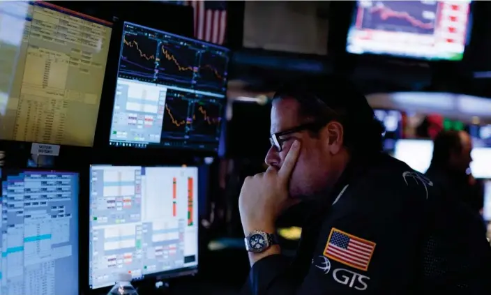  ?? Photograph: Justin Lane/EPA ?? A trader at the New York Stock Exchange earlier this month watching the Dow Jones fall on comments that the central bank was likely to raise interest rates.