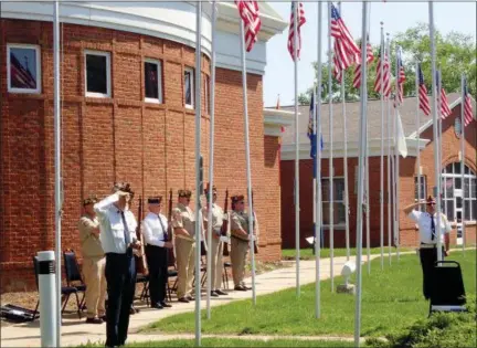  ?? JONATHAN TRESSLER — THE NEWS-HERALD ?? Members of Eastlake’s American Legion Post 678 and Veterans of Foreign Wars Post 3863 pause and render the appropriat­e salutation­s while Taps is played May 28 during Eastlake’s 2018 Memorial Day ceremony at The Boulevard of 500 Flags, 35150 Lakeshore...