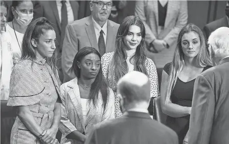  ?? ANNA MONEYMAKER/ GETTY IMAGES ?? U. S. gymnasts, from left, Aly Raisman, Simone Biles, McKayla Maroney and Maggie Nichols stand at a Senate hearing in 2021. On Wednesday, a federal tort claim was filed by attorneys representi­ng 13 gymnasts.