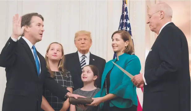  ?? Picture: JIM WATSON/AFP ?? PLEDGE: Brett Kavanaugh is sworn in as Associate Justice of the US Supreme Court by retired Associate Justice Anthony Kennedy before wife Ashley Estes Kavanaugh, daughters Margaret and Elizabeth, and US President Donald Trump at the White House in Washington, DC.
