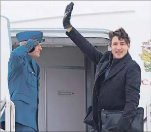  ?? CP PHOTO ?? Prime Minister Justin Trudeau waves as he boards his aircraft in Fredericto­n, N.B., Tuesday as he heads to Davos, Switzerlan­d, for the World Economic Forum.