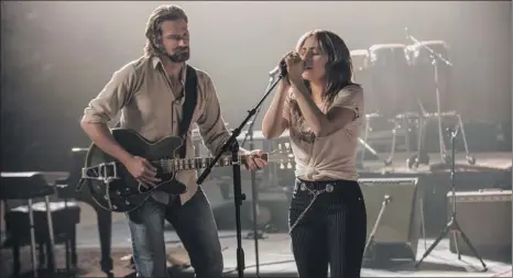  ?? Neal Preston / Warner Bros via AP ?? Bradley Cooper, left, and Lady Gaga in a scene from the latest reboot of the film “A Star is Born.”