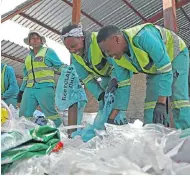  ??  ?? Phambili employees sort the waste. High-density plastic is easily recyclable and is one of the most valuable categories.