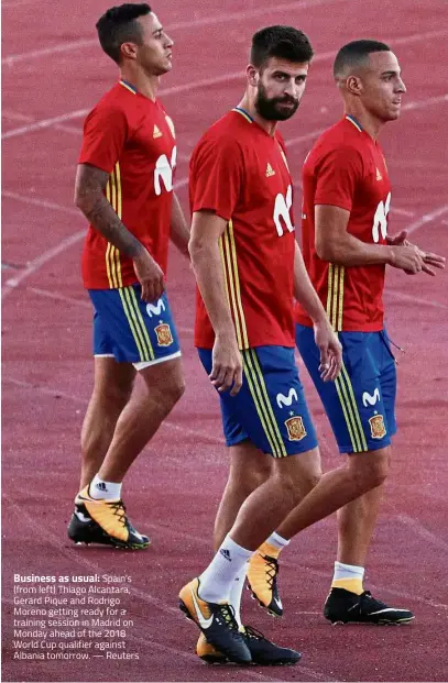  ??  ?? Business as usual: Spain’s (from left) Thiago Alcantara, Gerard Pique and Rodrigo Moreno getting ready for a training session in Madrid on Monday ahead of the 2018 World Cup qualifier against Albania tomorrow. — Reuters