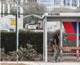  ?? Brett Coomer / Staff photograph­er ?? A man waits at a bus stop Wednesday next to the COVID-19 vaccinatio­n supersite at NRG Park. Vaccinatio­ns there are drive-thru only.