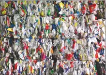  ?? Canadian Press photo ?? Recyclable materials compressed into large cubes are stacked at the Dufferin Waste Management facility in Toronto. Every year, tonnes of plastic waste are burned on farms around Alberta and across Canada. More is simply buried or dumped in municipal...