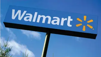  ??  ?? In this Nov. 18, 2020, file photo, a Walmart store sign is visible from Route 28 in Derry, N.H. Walmart Inc., reported on Thursday, Feb. 18, 2021, that it swung to a loss in the fiscal fourth quarter as the sale of its Japan and United Kingdom divisions weighed on results. (AP Photo/Charles Krupa, File)