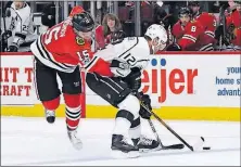  ?? ASSOCIATED PRESS] [MATT MARTON/THE ?? Los Angeles Kings right wing Marian Gaborik (12) and Chicago Blackhawks center Artem Anisimov (15) vie for the puck during the first period Sunday in Chicago.