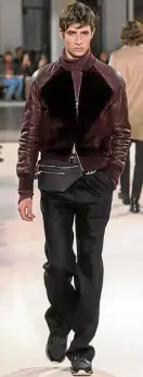  ??  ?? Blouson with ribbing in winered cable-effect sheepskin; turtleneck pullover in string six-ply cashmere; one-pleat large trousers in black cotton gabardine