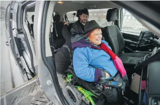  ?? JOHN MAHONEY ?? Driver Taoufik Besbes helps secure Carole Cartier’s wheelchair in his adapted transit vehicle, with her boyfriend Guy Simard in the back. Cartier has been in a wheelchair her whole life and says the STM has improved services for passengers with...