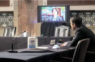  ?? — AFP photo ?? US Senator Amy Klobuchar questions Judge Justin Walker remotely by video link as he sits in a sparsely attended hearing room during Walker’s Senate Judiciary Committee confirmati­on hearing on his nomination to be a US Circuit Court judge for the District of Columbia Circuit on Capitol Hill in Washington, DC.