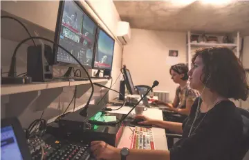  ??  ?? Technician­s and producers work in a control room during an internet broadcast in a studio at the Medyascope headquarte­rs.