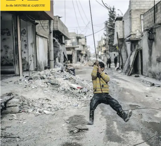  ?? ASIN AKGUL / AFP / GETTY IMAGES ?? A Kurdish Syrian boy plays among destroyed buildings in the town of Kobani. According to the UN, Syria has lost 2.1 million homes, 7,000 schools and half its hospitals.