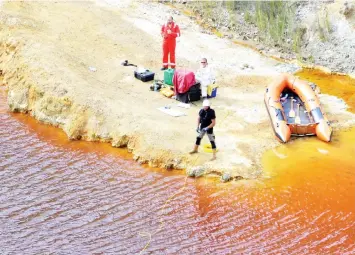  ??  ?? Forensics officers search Kokkinopez­oula lake, also known as ‘red lake’, for possible bodies of victims of a suspected serial killer near the village of Mitsero, Cyprus. — Reuters photo
