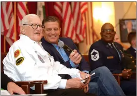  ?? NWA Democrat-Gazette/ANDY SHUPE ?? James Downing, a 104-year-old Pearl Harbor survivor and World War II and Korean War Navy veteran, speaks Thursday alongside assistant Larry Watkins and Bryan Matthews, medical center director, during a Veterans Day ceremony at the Veterans Health Care...