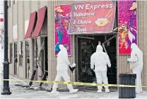  ??  ?? Police investigat­e the Fort Saskatchew­an restaurant where police say murder suspect Phu Lam took his own life early Tuesday.