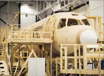  ?? BOMBARDIER AEROSPACE ?? The first flight for Bombardier’s CSeries plane, shown in a wooden model, was planned for the end of last year, but the target date has now been pushed to the end of June.