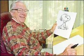  ?? AP ?? File photo shows the late cartoonist Charles Schulz displaying a sketch of his beloved character ‘Snoopy’ in his office in Santa Rosa, California.