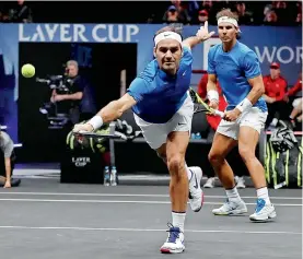  ?? AP ?? Europe’s Roger Federer reaches for a shot as his doubles partner Rafael Nadal watches during their Laver Cup match against World’s Jack Sock and Sam Querrey in Prague, Czech Republic. Federer-Nadal won 6-4, 1-6, 10/5. Europe lead World 9-3. —
