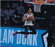  ??  ?? Portland’s Anfernee Simons won the Slam Dunk contest during halftime of the NBA All-Star Game in Atlanta.