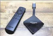  ?? ELAINE THOMPSON — THE ASSOCIATED PRESS FILE ?? The Amazon Fire TV streaming device plugs into the back or side of a television set to stream Netflix and other video.