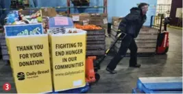  ?? ANDREW FRANCIS WALLACE/TORONTO STAR ?? Food bank driver Paul Huckvale tows donations at the warehouse on New Toronto St.