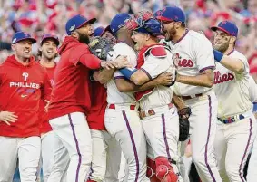  ?? Tim Nwachukwu/Getty Images ?? The Phillies celebrate after defeating the Braves on Saturday in Philadelph­ia to win their National League Division Series 3-1 over the defending champions.