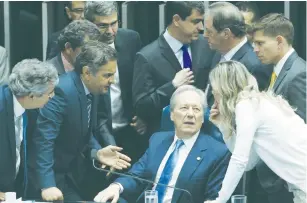  ?? (Adriano Machado/Reuters) ?? SUPREME COURT President Ricardo Lewandowsk­i (seated) speaks with senators during a discussion before the Senate voted to put suspended President Dilma Rousseff on trial for impeachmen­t in Brasilia yesterday.