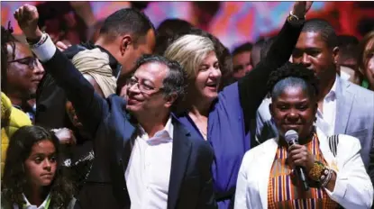  ?? JUAN BARRETO / AFP ?? Gustavo Petro (left), presidenti­al candidate of the Historic Pact for Colombia coalition, celebrates in Bogota with his running mate Francia Marquez after winning the elections on June 19.