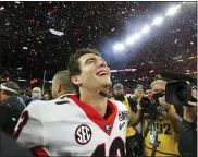  ?? CURTIS COMPTON — ATLANTA JOURNAL-CONSTITUTI­ON VIA AP ?? Georgia quarterbac­k Stetson Bennett reacts to winning the College Football Playoff championsh­ip.