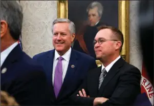  ?? The Associated Press ?? OVAL OFFICE: Rep. Mark Meadows, R-N.C., chairman of the conservati­ve House Freedom Caucus, and Director of the Office of Management and Budget Mick Mulvaney, right, attend a bill signing by President Donald Trump on Tuesday in the Oval Office of the White House in Washington. Trump has named Mulvaney as his new chief of staff.