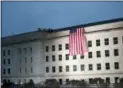  ?? PABLO MARTINEZ MONSIVAIS — ASSOCIATED PRESS ?? In Washington: A U.S. flag is unfurled at sunrise Tuesday, Sept. 11 at the Pentagon.