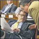  ?? BANDRES@AJC.COM
BOB ANDRES / ?? Rep. Alan Powell, R-Hartwell, confers with Rep. Rick Jasperse, R-Jasper, during Tuesday’s busy legislativ­e session.