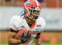  ?? BUTCH DILL/AP ?? American running back Kenny McIntosh of Georgia runs through drills in practice for the Senior Bowl on Thursday in Mobile, Ala.