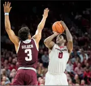  ?? NWA Democrat-Gazette/BEN GOFF ?? Jaylen Barford (right) of Arkansas goes up for a three-pointer as Admon Gilder of Texas A&M guards in the second half Saturday at Walton Arena in Fayettevil­le. Barford will be experienci­ng his first home game against Kentucky when the Wildcats visit at...