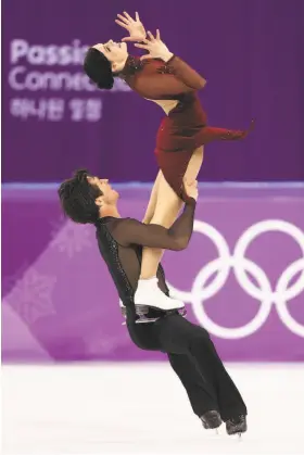  ?? Jamie Squire / Getty Images ?? Tessa Virtue and Scott Moir of Canada now have five career Olympic medals, most among figure skaters, though the team event began at 2014 in Sochi.