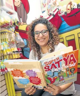  ?? NICOLAUS CZARNECKI / BOSTON HERALD ?? Author Raakhee Mirchandan­i reads from her new book ‘Super Satya Saves the Day’ at the Curious George Bookstore yesterday.