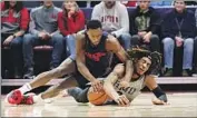  ?? Joshua A. Bickel Associated Press ?? R.J. BLAKNEY, left, of No. 20 Dayton battles for a loose ball with Kahliel Spear of Robert Morris.