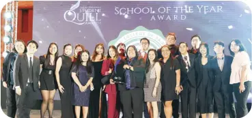  ?? ?? Members of the De La Salle University-College of Saint Benilde come to the stage as they claim the School of the Year award