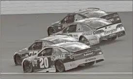  ??  ?? Matt Kenseth (20); Erik Jones (77); Kyle Larson (42) and Martin Truex Jr. (78) head into turn one on the last restart of the NASCAR Cup Series auto race in Brooklyn, Mich., Sunday, Aug. 13, 2017. Larson won the race.