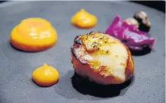  ??  ?? Hokkaido scallop with mashed sweet potatoes, carrot puree and a crispy mushroom.